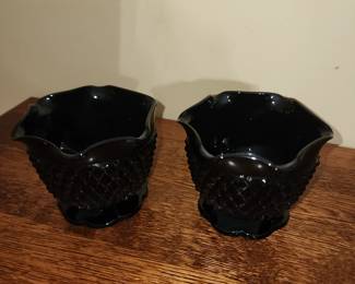 Pair of black cabdle holders 