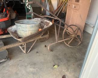 Antique push-plow, wheelbarrow, and old washtub