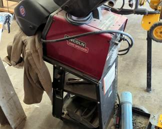 Lincoln Arc Welder, Model SP-125 Plus, With Welding Helmets, Supplies And Cart