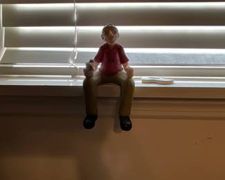 Man sitting in window sill