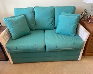 $100 Rattan love seat 56x36x24 teal cushions match rattan chairs in sunroom
