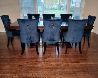Blue Velvet Chairs with Formal Wooden Dining Room Table that has two Leaves.