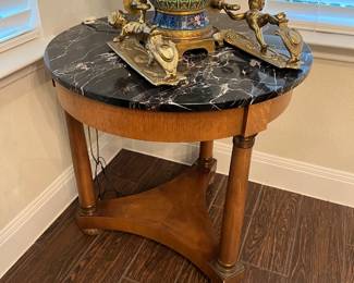 Marble top round end table with brass embellishments.