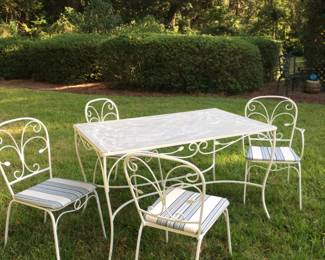 1970s wrought iron garden set. Chairs recently upholstered in sunbrella fabric the top is unique not glass but brushed aluminum (I think)