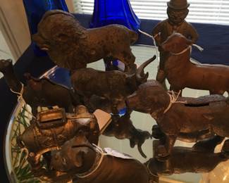 Old metal/iron bank collection.lion, dogs, elephant, camel, cow, deer, and clown