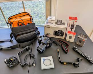 Like New Canon EOS Rebel SL3. With all  Canon original accessories. Used only for a maybe 50 pictures and 15 Vlog recordings. Has power adapter to run plugged in, USB cable to use as webcam. Also have a tripod that will be at the sale. Some miscellaneous attachment accessories and specialty audio cables.  Canon Extended Warranty through 5-6-24.