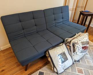 Futon Sofa with sheets, protective cover, and comforter
