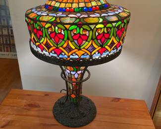 Table lamp with pill box hat shaped shade and rainbow colored glass.