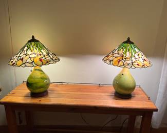A Pair of Lamps with green pottery bases and cala lily shades