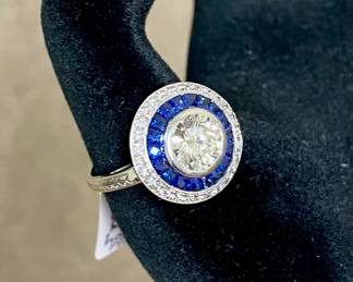1.3 Ct. Diamond center stone and sapphire halo ring. Comes with jewelers appraisal report. 