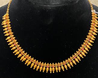 22K gold from India set with cabochon emeralds and rubies. 