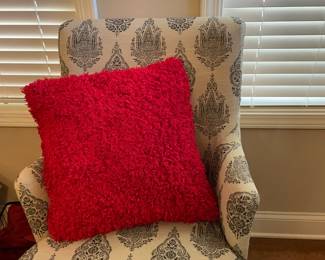 matched set white patterned armchairs with red accent pillows