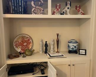 collection of chinese-style china dog statues, plates, jars in blue and white, red and white, candlesticks, figurines, curios.