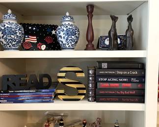 collection of small lighthouses, blue and white vases, crystal book ends, books, curios