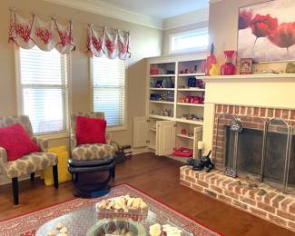 Home accents, black and white armchairs, glass coffee table, curios, fireplace screens