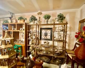 The wall is full of silver plated serving trays pitchers and saucers. All very beautiful!