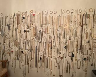 Lots of custom jewelry and custom pearls and other materials in this wall of jewelry!