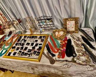 Lots of beautiful necklace pieces abs a frame full of pretty earrings!