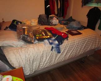 Queen bed full of vintage hats, denim and more