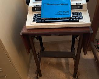 SITTING ON A VINTAGE TYPING TABLE.