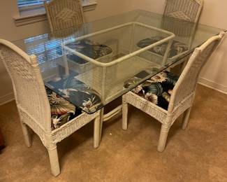 White wicker glass top table and 4 chairs. Table 72”w 42”d 29” t chairs 17”w 16”d 36”t  19”fl to seat.  $175.00