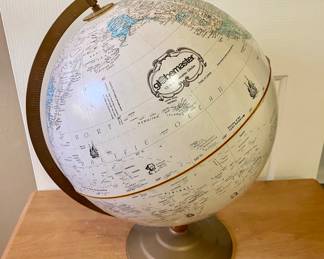 Globe on metal stand by "Replogle Globes Inc".
