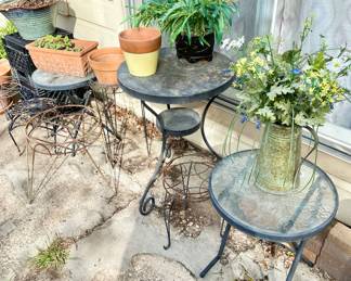 Garden patio tables and lots of clay planters.