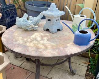 Iron base stone top patio table, watering cans & decor.