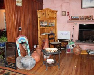 Several pots and fun pottery in back bookshelf