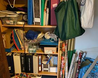 Stacks of needlepoint and cross stitch books and patterns.