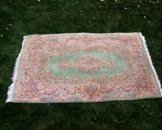 Lot 55:  Semi-Antique Kirman Rug, light green field w/scroll and floral borders, all wool.  2' 10" x 5'.  Cond: End fringe shows moderate wear, no stains or tears. Est. $ 75 - 125.