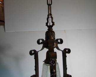 Lot 48: C/1915 Hanging Brass and Iron Hallway lamp, applied brass torch and flower blossom decorations, etched shade, 26" h. x 9" dia.  Purchased from Materials Unlimited. Cond: Polished, lacquered and entirely rewired, minor gilt paint flaking on edges.  Est. $75 - 100.
