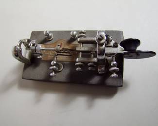 Lot 82:  C/1920 "Vibroplex" speed telegraph key (Sender), nickel plated on heavy steel base.  Brass manufacturing tag, 8" l. x 4" w. x 3" h.  Cond:  Minor wear from use.   Est. $150 - 250.