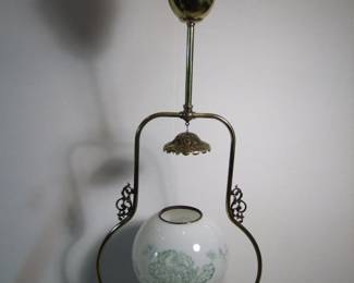 Lot 37: C/1880 Brass hanging Oil lamp, gravity fed with upper reservoir, electrified.  48" h. x 14" w. x 8" deep.  Purchased from Materials Unlimited.  Cond:  Polished and lacquered, no damage to shade, dent on top edge of upper reservoir.  Est. $150 - 250.