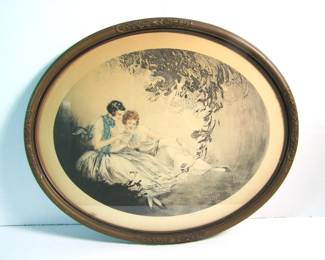 Lot 4: Dated 1925 Icart style oval print of 2 girls reading a romance novel, pencil signed "J.B. Henricy"(AKA Jean Hardy, French born 1880)  in its original gilt frame, 21 1/2" x 17 1/2".  Cond:  Light toning overall, very small water stain in lower left area, frame has minor wear.  Est. $100-150.