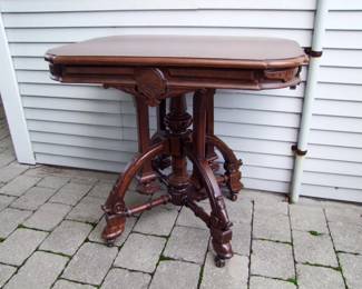 Lot 43:  C/1880 Walnut Renaissance Revival Parlor Lamp Table with applied burl sections, single board top, dbl. castered feet, professionally refinished, 35" L. x 24" w. x 31" tall.  Cond:  No damage found. Est. $250 - 450.