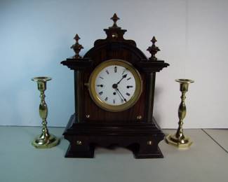 Lot 30: C/1880 English Mantle Clock, 3 hole dial, faux Rosewood grained case w/brass trim.  Includes pair of C/1880 English brass candlesticks.  Cond:  No damage found, polished and lacquered, clock runs then stops.  Has key and makeshift pendulum.   Est. $150 - 200.