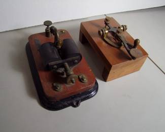 Lot 83:  C/1890 Brass and Iron Telegraph set includes signed "JH Bunnell & Co.", (Sender was table mounted originally and now has custom cherry wood stand) 7" x 4" x 3 1/2".  Also includes a signed "JH Bunnell & Co." receiver with cast iron stand, 9" x 5" x 4".  Cond:  Minor wear to sender, moderate wear to receiver from use.  Est. $150 - 250.