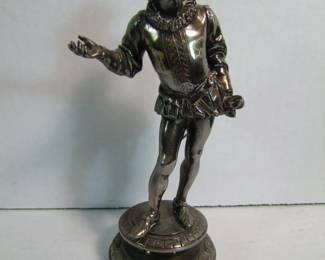 Lot 51: C/1880 English Silver on Bronze Shakespeare figure on a circular base, 8" h. signed on base (Not readable).  Cond: Silver is tarnished, no damage found.    Est. 75 - 125.