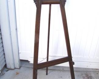 Lot 42:  C/1880 Quartered Oak Victorian Easel, carved crest, complete with original good finish, 60" h. x 29" w. x 4" deep.  Cond:  Minor wear.   Est. $125 - 175.