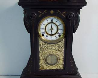 Lot 34: C/1880 Ebonized Cherry mantle clock signed F. Kroeber, NY, inlaid crown and base, original beveled glass and brass pendulum and porcelain dial, time and strike, 8 day movement, 13" x 5" x 21" h., key present.  Cond: Light wear on crown and base, hairline fracture on dial around center hands post.  Running when photographed.    Est. $150 - 250.