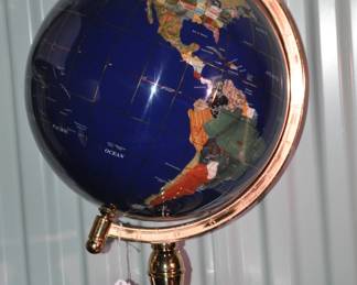 A Timeless Piece in Any Setting, This World Globe Features Inlaid Semi-Precious Gemstone Throughout Giving The Surface a Multitude of Bright Colors. You Will Additionally Appreciate the Complimentary Brass Stand. 20"H, ($65).
