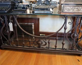 Antique wrought iron glass topped table, vintage typewriters, antique cash register
