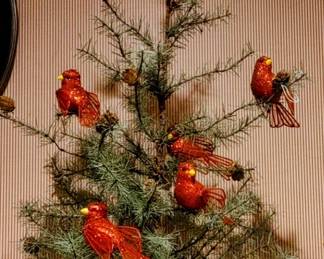 Little Christmas tree with pine cones and red Cardinals