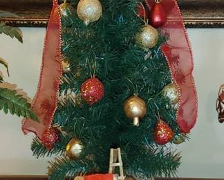 Little evergreen tree with pomegranate ornaments burlap base