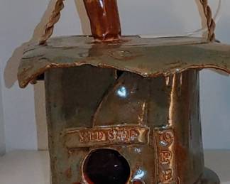 Pottery bird feeder reads "Seed Shop" van be used outside