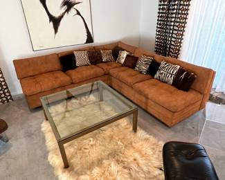 This is by far the coolest sectional we’ve ever sold! I cannot find a makers tag on it, but it’s made incredibly well and the entire pieces covered in super thick suede that is actually really comfy