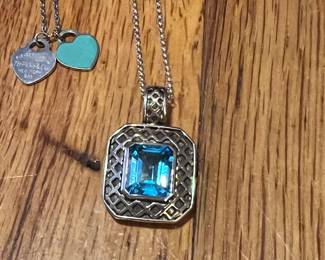 Amazing blue topaz pendant encased in a lattice work of sterling silver and gold!