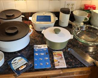Kitchen items: Thomas Flammfest casseroles, Corning Ware, Krups coffee grinder, Pyrex pie pan, Chinese cleaver