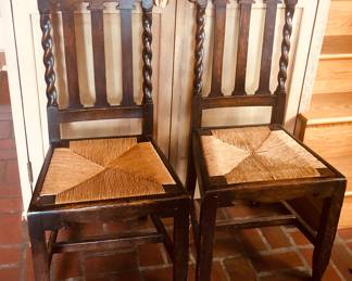 Two of set of 8 antique dining chairs with rush seats (38.5” high at back, 17.5” wide at front)